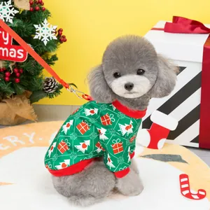 Poodle wearing a green Christmas tree pet sweater with red ribbed edges and festive prints