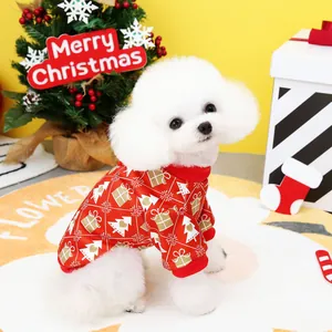 White dog wearing red Christmas tree printed pet sweatshirt in festive holiday setting