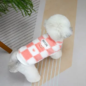 Detail of pink plaid fleece pet vest with brand label and D-ring for leash attachment
