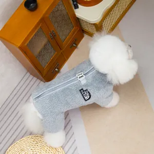 Gray plush pet jumpsuit with back zipper and D-ring for leash on a white dog