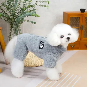 Close-up of plush grey pet onesie with black label on a small white poodle dog