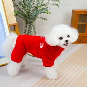 Close-up of red fleece pet jumpsuit with white embroidery detail on a bichon dog