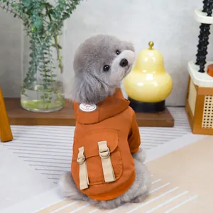 Orange pet hoodie with cargo pocket and D-ring detail on a poodle model