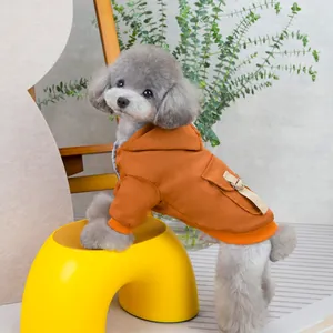 Detail of warm orange hooded pet jacket with pocket and soft faux fur lining for dogs