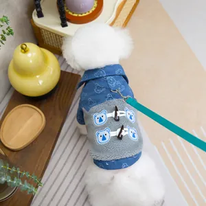 Blue denim and fleece pet coat with bear patches and duffle buttons on a Bichon dog