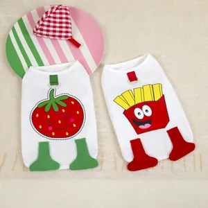 Two white cotton pet vests with cartoon strawberry and fries patterns and D-rings