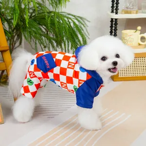Detail of checkered pet jumpsuit with blue pocket and Happy print on dog model