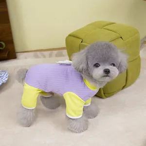 Detail of purple pet onesie with yellow cuffs and white 3D wings on the back