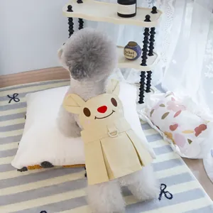 Close-up of pet dress showing beige cotton fabric, bunny embroidery and a D-ring for leash