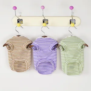 Striped cotton pet t-shirts in brown, lavender and green on wooden hangers