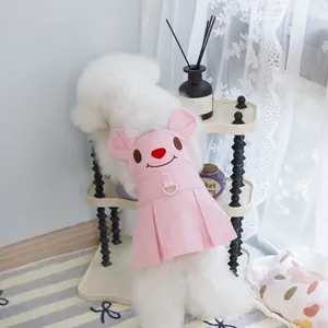 Detail of pink pet dress featuring a cartoon bear face and a metal D-ring for leashes