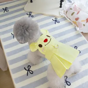 Detail of yellow pet dress featuring cartoon embroidery and functional D-ring leash attachment