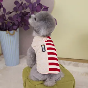Detail view of pet vest featuring a metal D-ring and red-white striped contrast design