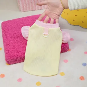 Yellow waffle knit pet vest with pink ruffle sleeves and D-ring for leash attachment