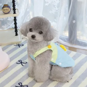 Detail of pet dress with a 3D yellow chick doll on light blue and green patchwork fabric