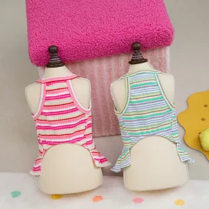 Pink and rainbow striped knit pet vests for cats and dogs on display stands