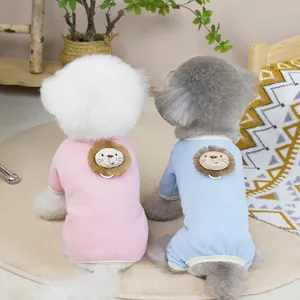Pink and blue lion patchwork pet onesies for dogs and cats on a cozy beige rug