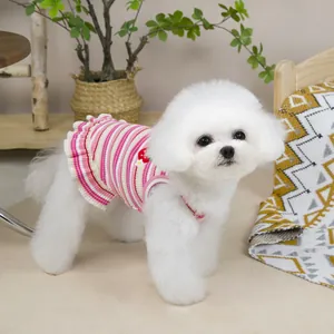 Close-up of pink striped pet dress with strawberry flower embroidery on small dog