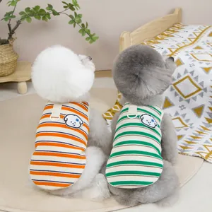 Striped pet knit vest with puppy embroidery and D-ring for cats and dogs on a cozy bed