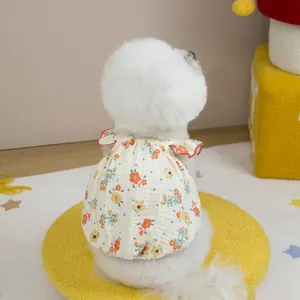 Detail of floral pet dress with ruffled collar and lightweight cotton gauze fabric
