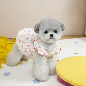Close-up of pet summer dress with peach prints and red ruffled collar on a small dog