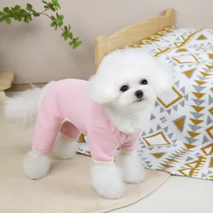 Close-up of pink waffle texture pet jumpsuit on a white dog in a cozy home setting
