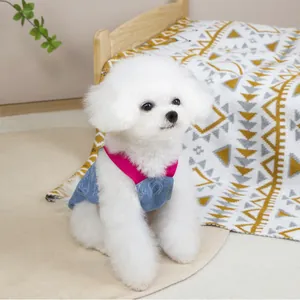 Denim pet vest with pink trim and white print on a Bichon Frise dog for summer