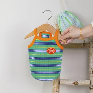 Colorful striped pet vest with orange trim and Good Luck embroidery on mini hanger