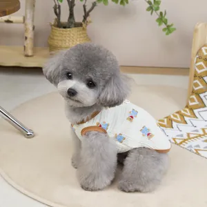 Close-up of cotton waffle dog vest featuring cartoon bear prints and brown piping