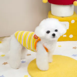 Detail of colorful striped pet vest with orange trim and Good Luck badge on small dog
