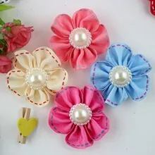 Detail of 5-inch textured ribbon flower hair clips with large pearl center in four colors