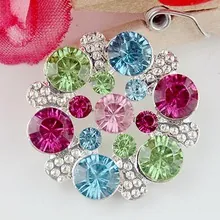 Detailed macro shot of a colorful crystal flower brooch with vibrant rhinestones