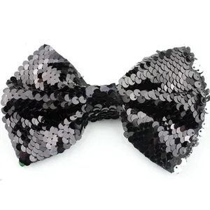Detailed macro view of black sequin bow accessory with gold foil fish scale texture