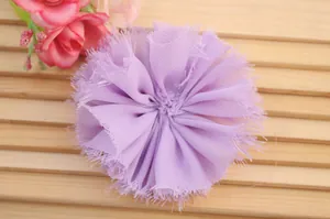 Detail of light purple chiffon fabric flower with frayed edges and soft layered petals