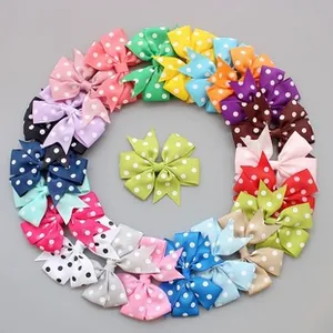 Detailed flat lay of premium polka dot grosgrain ribbon bows in various vibrant colors