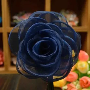 Macro detail of navy blue handmade chiffon rose with layered petals for DIY crafts