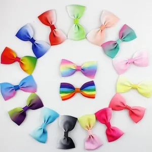 Flat lay of sixteen 12cm glitter bows in vibrant colors for hair and DIY accessories