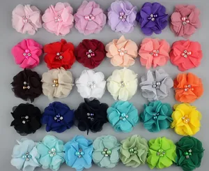 Multi-colored chiffon flowers with pearls and rhinestones shown in a neat 30-piece grid layout