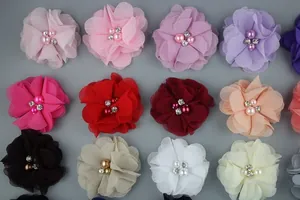Macro shot of colorful chiffon flower hair clips with pearl and rhinestone centers