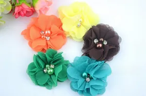 Detail of colorful chiffon fabric flowers with central pearls and sparkling rhinestones