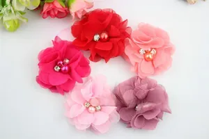 Detail of colorful chiffon fabric flowers with central pearl and rhinestone accents