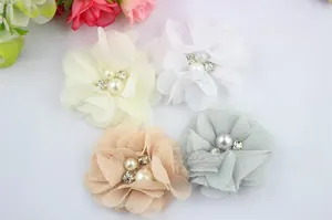 Detail of chiffon flower hair clips with pearls and rhinestones in soft pastel colors