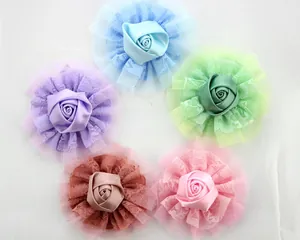 Detail of multi-layered lace and satin ribbon rose accessories in five pastel colors