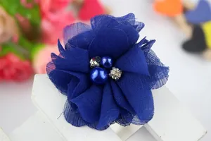 Detailed view of navy blue chiffon flower with elegant pearls and sparkling rhinestones