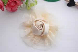 Detail of handmade cream lace flower with satin rose for baby hair accessories