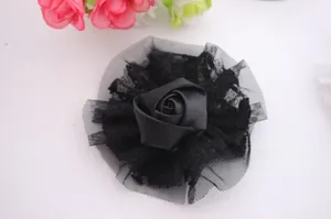 Macro shot of black satin rose with layered lace and mesh fabric for baby hair accessories