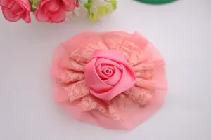 Close-up of pink satin ribbon rose with double-layer lace and mesh details for baby hair flower