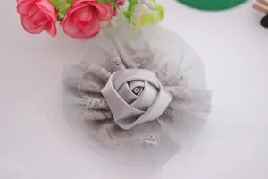 Detailed view of handmade double-layered lace and satin rose flower for baby hair accessories