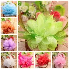 Detail of layered ruffled flower hair clips featuring rhinestones and feathers in various colors