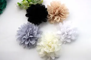 Flat lay of multi-layered chiffon fabric flowers in black, pink, grey, and white tones